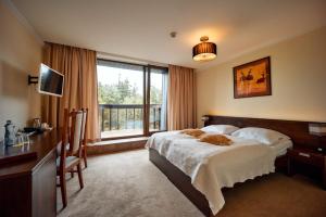 Un pat sau paturi într-o cameră la President Hotel Montfort