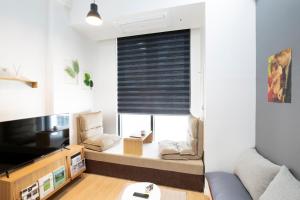 a small living room with a couch and a window at Busan Studio 202 in Busan