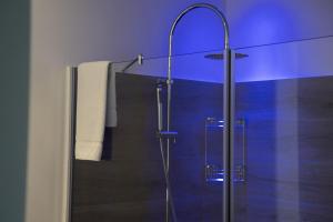 a bathroom with a shower with a glass door at Luxmarì Hotel & Spa in Castellammare del Golfo
