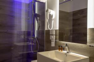 a bathroom with a shower with a sink and a shower at Luxmarì Hotel & Spa in Castellammare del Golfo