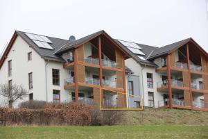 an apartment building with solar panels on its roof at Ferienwohnung Bergwiese in Winterberg