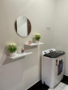 a bathroom with a mirror on the wall and a toilet at Unique apartment in Mombasa