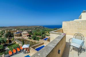 a view of the ocean from the balcony of a house at Hanini Holiday Home in Qala