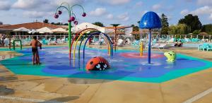 a swimming pool with a water park with a playground at Bungalow charmant au cœur de Les Mathes avec piscine partagée in Les Mathes +12 photos
