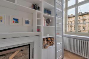 a living room with a fireplace and a window at Appartamento Conte Verde 1756 - Storie e Dimore in Turin