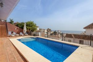 a swimming pool with a view of the ocean at Exclusive Villa - Great Sea View in Nerja