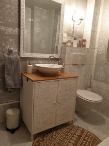 a bathroom with a sink and a toilet at Stillvolle Designwohnung im historischen Zentrum in Stolberg