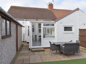 an extension to a house with a table and chairs at The Bungalow in Thornton