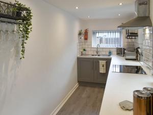 a kitchen with white walls and a counter top at The Bungalow in Thornton