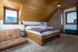 a bedroom with a bed and a couch in a room at TATRYSTAY Family Villa Rosa in Stará Lesná +13 photos