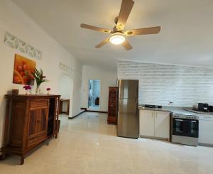 a large kitchen with a ceiling fan and appliances at Kaz Memel in Beau Vallon