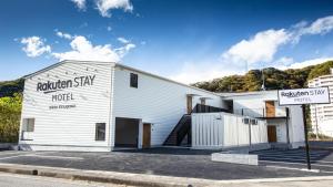 un edificio blanco al lado de una calle en Rakuten STAY MOTEL Nikko Kinugawa Standard Room en Nikko