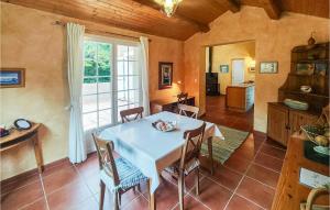 une cuisine et une salle à manger avec une table et des chaises blanches dans l'établissement Awesome Home In Ferrières-Poussarou, à Ferrières-Poussarou