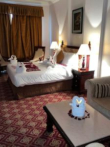 a hotel room with a bed and a table at Diwan Al Amir in Khasab