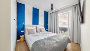 Posteľ alebo postele v izbe v ubytovaní Apartamenty Sun & Snow Polanki Aqua z basenem