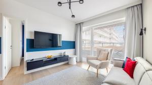 Televízia a/alebo spoločenská miestnosť v ubytovaní Apartamenty Sun & Snow Polanki Aqua z basenem