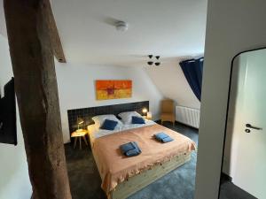 a bedroom with a bed with two blue pillows at Gasthof Strietholt in Everswinkel