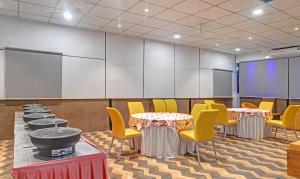 a conference room with tables and chairs and a projector at Treebo Trend Merit in Indore