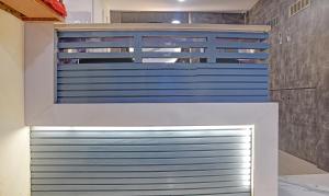 a garage with a blue and white garage door at Treebo Trend Merit in Indore