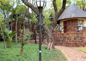 a street light in front of a stone building at Olifants River Lodge by Dream Resorts in Middelburg