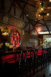 a bar with a row of chairs in a restaurant at Travel Hub Guesthouse in Kuala Lumpur