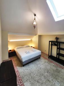 a bedroom with a large bed and a skylight at Sant Jordi Hostels Lisbon in Lisbon