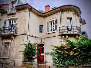 Casa grande con puerta roja y balcón. en Studio cosy, hyper centre d'Aix, vue montagnes, proche thermes, en Aix-les-Bains