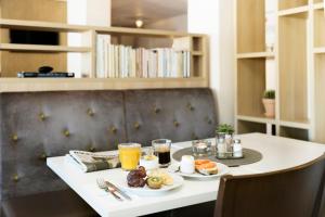 a breakfast table with two plates of food on it at Good Morning+ Göteborg City in Gothenburg