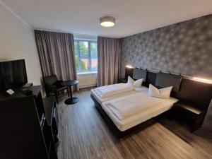 Postel nebo postele na pokoji v ubytování Nordic Avantage Hotel