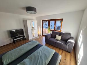 a living room with a couch and a tv at Ferienwohnung Scharf in Reutte