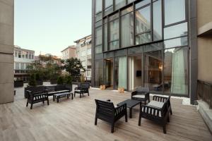 a group of benches sitting on a patio in front of a building at Gatto Suites&Residence in Istanbul