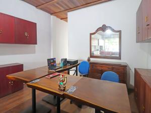 een lege kamer met twee tafels en een spiegel bij OYO 91807 Kemalasari Guesthouse in Jambi