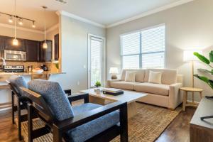 a living room with a couch and a table at Bright and Spacious Apartments with Gym and Pool Access at Century Stone Hill North in Pflugerville, Austin in Pflugerville
