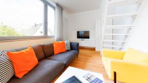 a living room with a couch and a tv at Ankerhaus Ankerhaus 4 in Hörnum