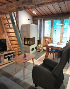 a living room with a couch and a table at Salmikangas G4 in Ruka