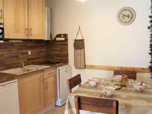 a kitchen with a table with chairs and a sink at Appartement Vars, 3 pièces, 6 personnes - FR-1-330B-33 in Vars