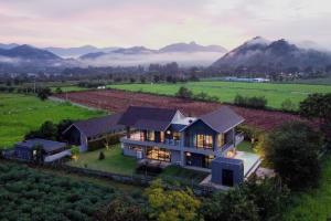 an aerial view of a house with mountains in the background at twoDO KhaoYai in Mu Si