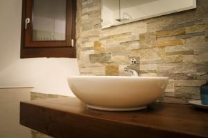 a bathroom with a bowl sink on a counter at La Casa dei Gatti in Limone Piemonte