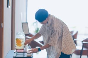 a man standing next to a table with a drink at SEKIYA RESORT Terrace Midoubaru in Beppu +58 photos
