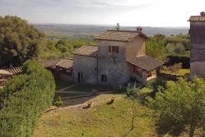 an aerial view of an old stone house with trees at Il Fortino - Happy Rentals in Monteriggioni