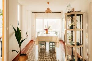 a dining room with a table and a potted plant at El Riu del Cel in Lloret de Mar