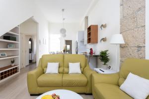 a living room with a yellow couch and a table at Home2Book La Casita del Mercado in Santa Cruz de Tenerife