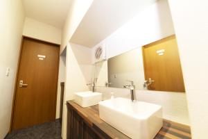 a bathroom with a white sink and a mirror at NY Cottage B in Tokyo +32 photos
