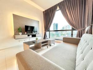 a living room with a couch and a tv at SKS Pavillion Residence by Luxecocoo CK Johor Bahru City Centre in Johor Bahru