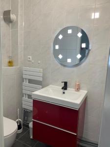 baño con lavabo rojo y espejo en StarHouse Ferienwohnung Hamburg en Hamburgo
