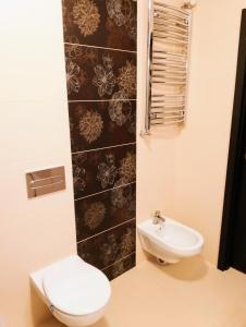 a bathroom with a toilet and a sink at Apartament Warmińska in Barczewo +14 photos