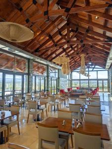 ein Restaurant mit Holzdecken und Tischen und Stühlen in der Unterkunft Altitud 720 Hotel, Aparts & Spa in Villa General Belgrano
