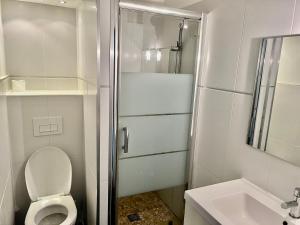a bathroom with a toilet and a shower and a sink at Hôtel L'Eau Des Collines in Marseille