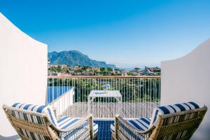 eine Terrasse mit 2 Stühlen und einem Tisch auf dem Balkon in der Unterkunft HOTEL ZI'NTONIO in Scala