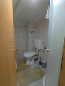 a bathroom with a white toilet in a room at Biba in Mostar
